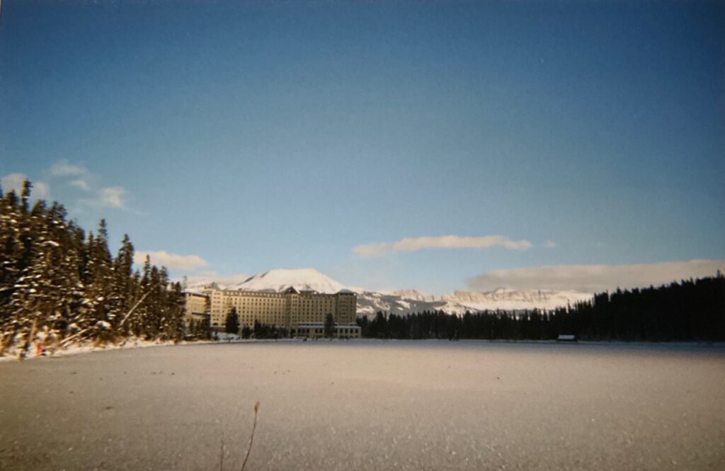 the frozen Lake Louise; view from the other side of the "Chateau"; trees around it and the Rockies behind